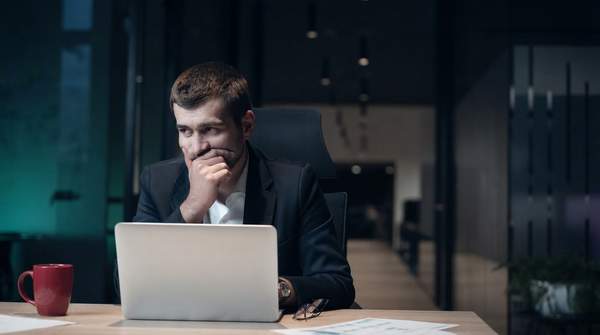 A founder diligently studying at a desk, surrounded by learning resources, symbolizing the importance of continuous founder development for startup success.