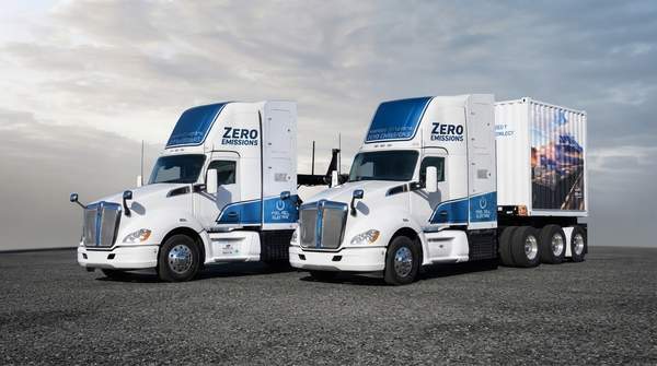 A futuristic Toyota IVECO hydrogen fuel cell truck on a highway at sunrise, representing sustainable long-haul logistics and clean transportation.